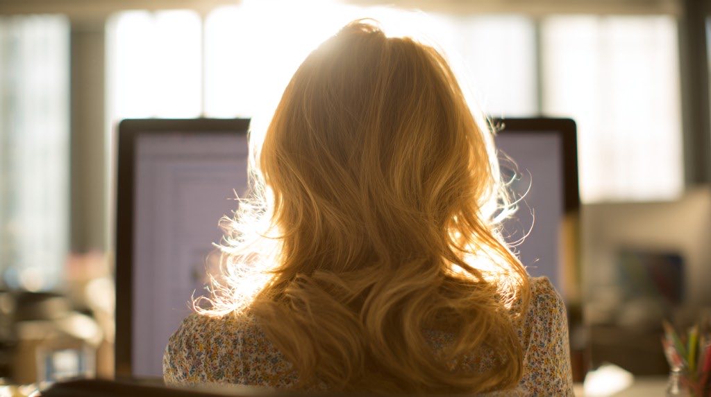 Person working at a computer with bright backlight
